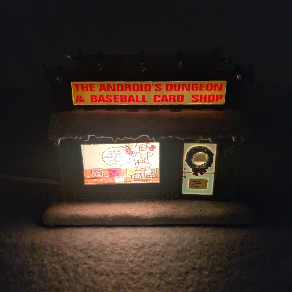 The Simpsons Android's Dungeon Baseball Card Shop Christmas Village Building - Picture 2 of 7